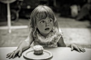 Little girl eating a dessert